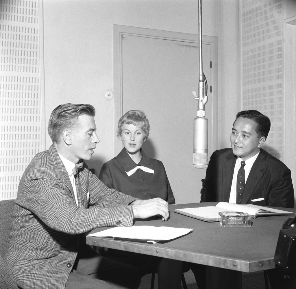 Reporter of the Finnish Broadcasting Corporation Esko Tommola interviews Armi Hilario (former Armi Kuusela) and her husband Gil Hilario in a radio studio.