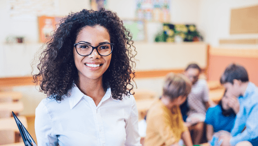 smiling teacher in a classroom